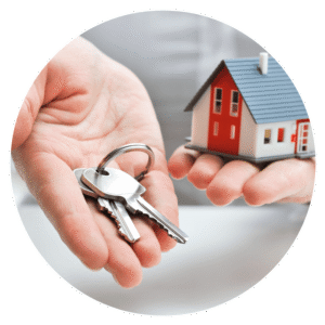 Happy home buyers receiving house keys after a successful real estate transaction in Portland, OR